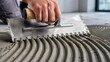 © MH24 - Notched trowel spreading tile adhesive, floor mortar application, tiler