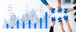 © InfiniteFlow - Hands holding puzzle pieces above a financial growth chart symbolize collaboration in business strategy. Ideal for themes of teamwork, innovation, and planning. Scalp