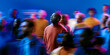 © Parisa - Thoughtful African American man standing still as vibrant neon crowd rushes past in blue and magenta