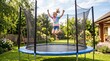 © Felippe Lopes - Joyful young girl with arms raised in excitement jumping high on a trampoline in a sunny backyard garden