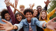 © Helga - International Friendship Day joyful friends group portrait outdoors, diverse young people laughing with arms raised, urban friendship celebration, authentic youth lifestyle, teamwo
