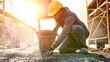 © Bonsales - Construction worker pouring fresh concrete, building foundation at outdoor renovation site during sunrise