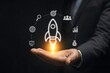 © Kunal - Businessperson holding a glowing rocket illustration symbolizing startup growth and innovation