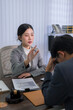 © snowing12 - Asian female lawyer attorney consulting client during legal advice meeting in modern law office discussing contract documents case strategy professional