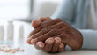 © Alexey - Senior woman holding hands on table with medicine. Rehabilitation after stroke and health care for aged patient. Support and medical assistance for elderly person during recovery process.