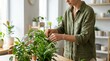 © Kaff - Woman Tending to Potted Houseplants Indoors
