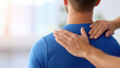 © Keopaserth - Physiotherapist examining male back in clinic, manual therapy for spine pain and muscle tension with hands on shoulder and neck