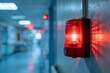 © shahjalal - A fire alarm strobe light flashing urgently on a wall in a commercial building during an evacuation emergency indicating warning safety alert and danger situation