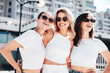 © halayalex - Three young beautiful smiling hipster female in trendy summer white t-shirt  and jeans clothes. Sexy carefree women posing in street. Positive models having fun, going crazy. In sunny day, sunglasses