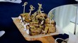 © Alexander - Grilled eggplant rolls stuffed with creamy cheese, toasted nuts, and aromatic herbs resting on rustic wooden surface, presenting elegant appetizer