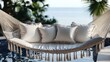 © Cipunk. 99 - Luxurious hammock with cushions by a pool, overlooking ocean.