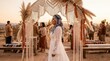 © mashimara - Boho desert wedding ceremony with bride smiling under macrame arch
