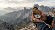 © Ompured - Hiker holding a vintage brass compass while trekking in the mountains