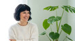 © shakil - Smiling woman posing with green leafy plant