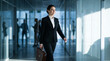 © Febi - Confident businesswoman walking through a modern office corridor with a briefcase, smiling and focused on professional success
