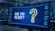 © Sarmad - A large screen displays a question mark and 'ARE YOU READY?' in a futuristic control room environment with technology and interface elements.