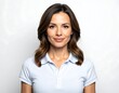 © Sela - A young woman with brown hair and a light blue polo shirt smiles