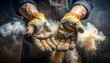 © Brody - Close-up view of worker's hands in worn leather gloves, holding a cloud of swirling dust against a dark backdrop