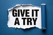 © Prazis Images - Motivational quote give it a try appearing under a dark blue torn paper texture