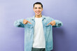 © AntonioDiaz - Smiling man pointing downwards at his white t-shirt, wearing a denim shirt, expressing self-confidence and pride