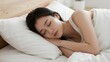 © TJAYZ - 57. A young woman sleeping peacefully in a comfortable bed with crisp white sheets, soft morning light gently illuminating her face, calm relaxed expression, cozy bedroom interior background, wellness