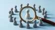 © Iwan - Human resources recruitment and talent acquisition concept with a magnifying glass searching for the right candidate among many employees