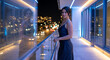 © Vyatcheslav - Elegant woman in black dress standing on modern city balcony at night. Portrait of female model with glass reflection and blurred street lights