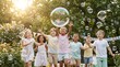 © HIFZA - Group of diverse happy children playing with floating soap bubbles in sunny park children childhood laughter