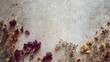 © fivan - A top view of dried flowers scattered lightly across a concrete background with intentional empty zones