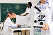 © Pixel-Shot - Teenage boy with microscope in Biology class at school, closeup