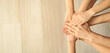 © Pixel-Shot - Young people putting hands together, top view. Concept of unity