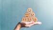 © Nicholas - hand holding stacked emotion faces mood change awareness stress and anxiety reflection emotional wellbeing monitoring psychological insight self check guidance emotion concept
