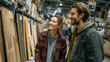 © Natalya - Smiling couple shopping for wood flooring in a home improvement warehouse. Choosing materials for a DIY renovation project