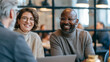 © Rostyslav - Diverse colleagues having friendly meeting in modern office interior