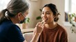© ymamoto - Doctor examining a young woman's throat with a tongue depressor in a medical setting