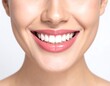 © Jum - A close-up of a woman's face showcasing her bright smile with pink lips and white teeth