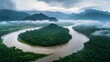 © BADAL - Serene river curves through lush mountains, enveloped by mist and dramatic clouds
