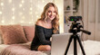 © Celt Studio - Gorgeous blonde camgirl performing cheerful adult interactive internet video stream using high quality digital camera and laptop computer inside cozy modern bedroom