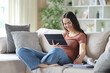 © Antonioguillem - Happy teenage student e-learning with tablet takes notes