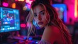 © Namput - Young Woman Looking at Camera Beside Computer Monitors in Neon Gaming Room