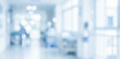 © birulaut - A blurred view of a hospital corridor featuring lights and medical equipment, creating a calm atmosphere, emphasizing a sterile healthcare environment.