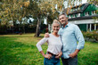 © Westend61 - Smiling man standing with arm around woman at backyard