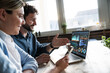 © Westend61 - Business team analyzing financial data on laptop in office