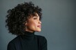 © Studio Nova - The woman in a black turtleneck gazing thoughtfully into soft studio light