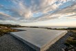 © Sekodong - Concrete House Foundation on a Scenic Coastal Hillside at Sunset