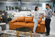 © Serhii - Client discussing furniture options with sales consultant in store