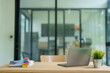 © MINAE - Modern office creating a productive environment with an open-plan workspace. Organizing documents using colorful binder clips for efficient workflow. And clean desk setup with laptop