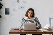 © (JLco) Julia Amaral - The woman builds a calm workspace at her home office desk