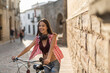 © Antonio Recena - Woman in european city driving her bike