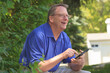 © Connect Images - Man with Cerebral Palsy and dyslexia using his tablet